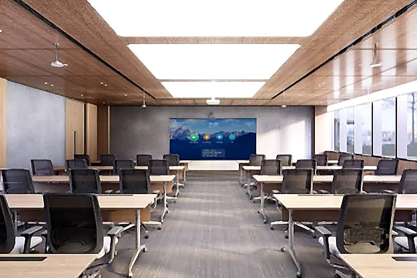 A training room with tiered desks facing a large display