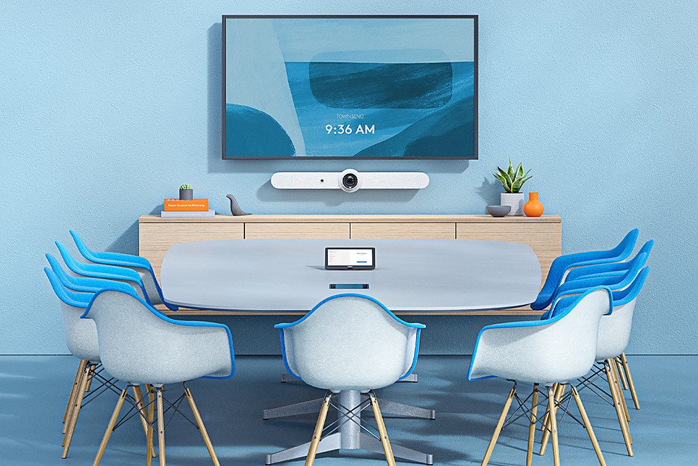 A meeting room with integrated video bar, display and table controller